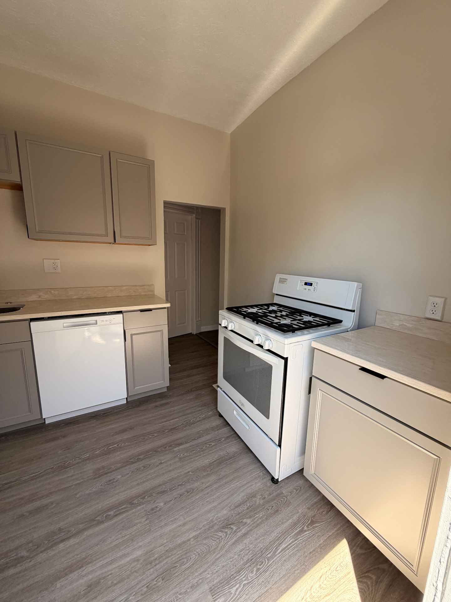 133½ kitchen with gas range, dishwasher and grey cabinetry