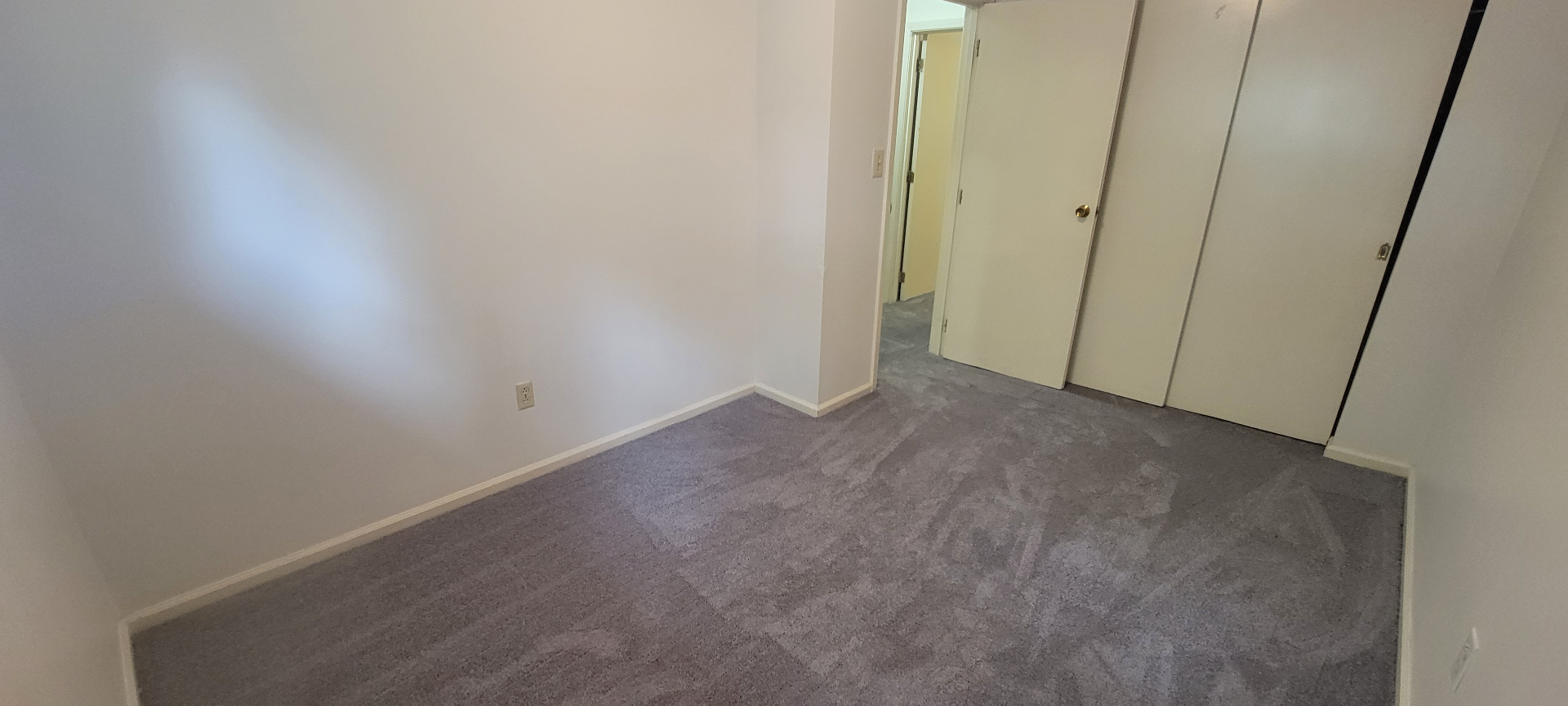 2022 Iuka Ave. bedroom with sliding closet doors and fresh grey carpet