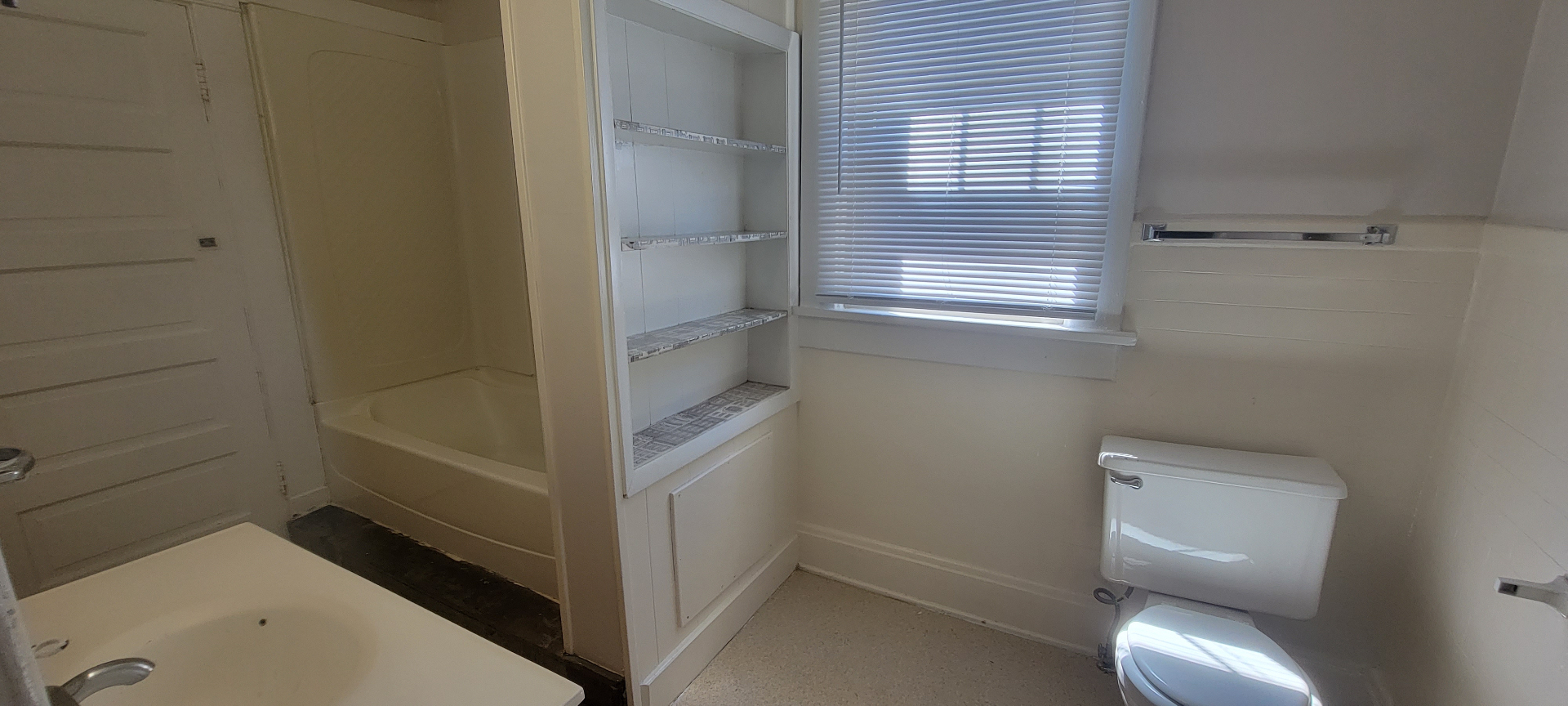 2015 Summit St. full bathroom with built-in shelving, vanity, and toilet