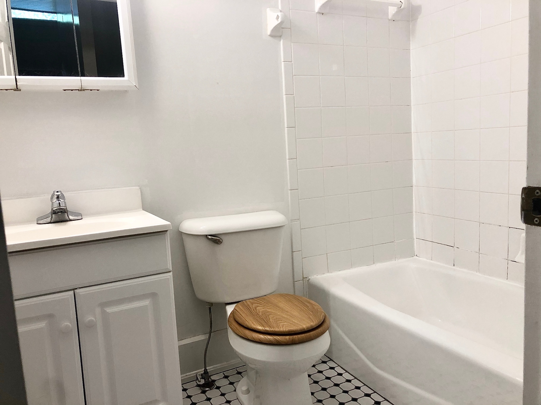 2034 Iuka Ave A bathroom with tub, tiled shower surround, and vanity