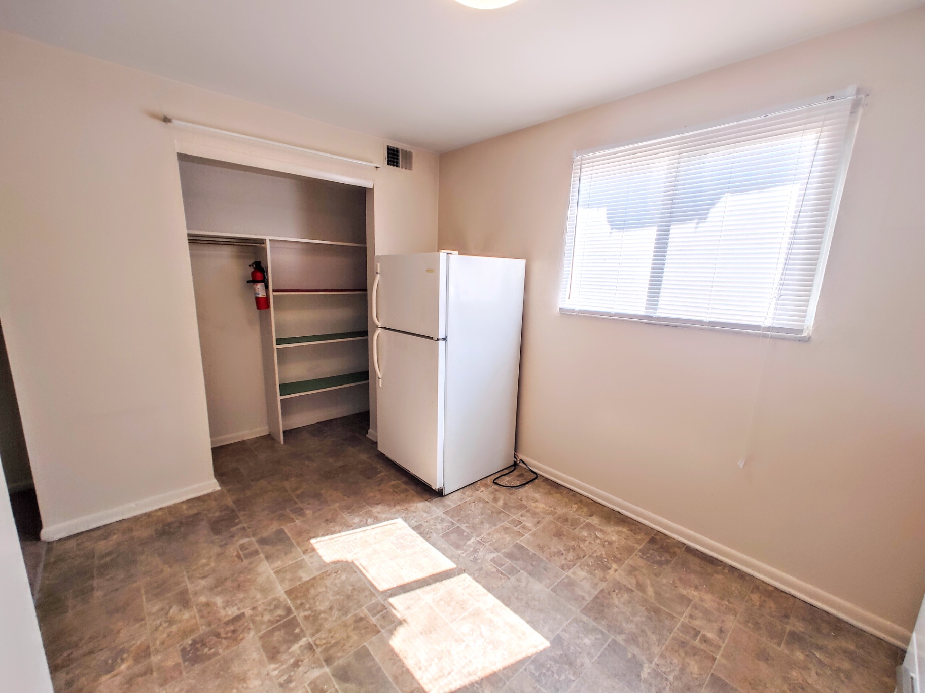 2150 N 4th St. Unit B kitchen area with built-in pantry shelving and fridge