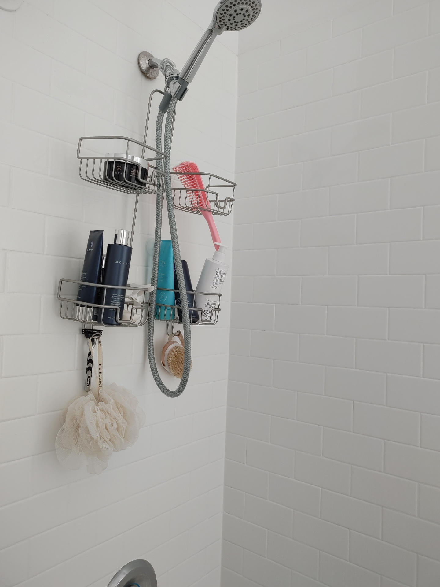 Unit G showerhead and white subway tile shower wall