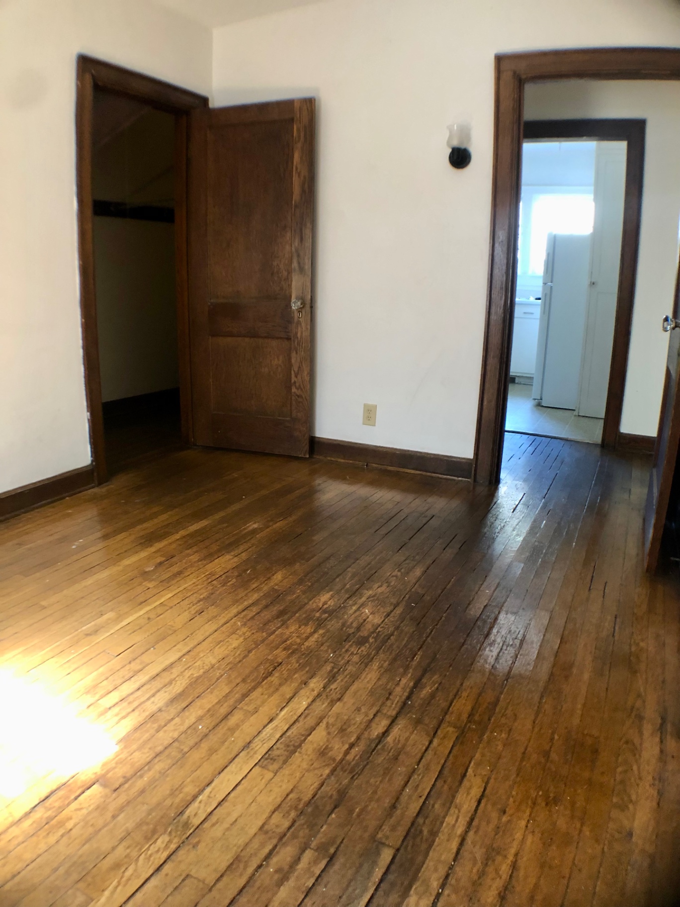 2044 Iuka Ave. A bedroom with hardwood floors, original wood trim, and closet