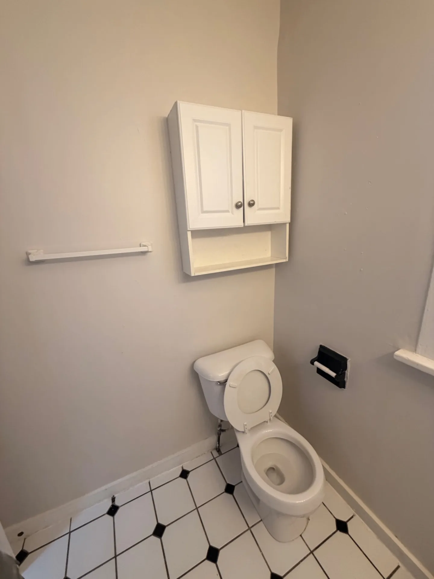 1816 Summit St. bathroom with over-toilet storage cabinet and tile floor