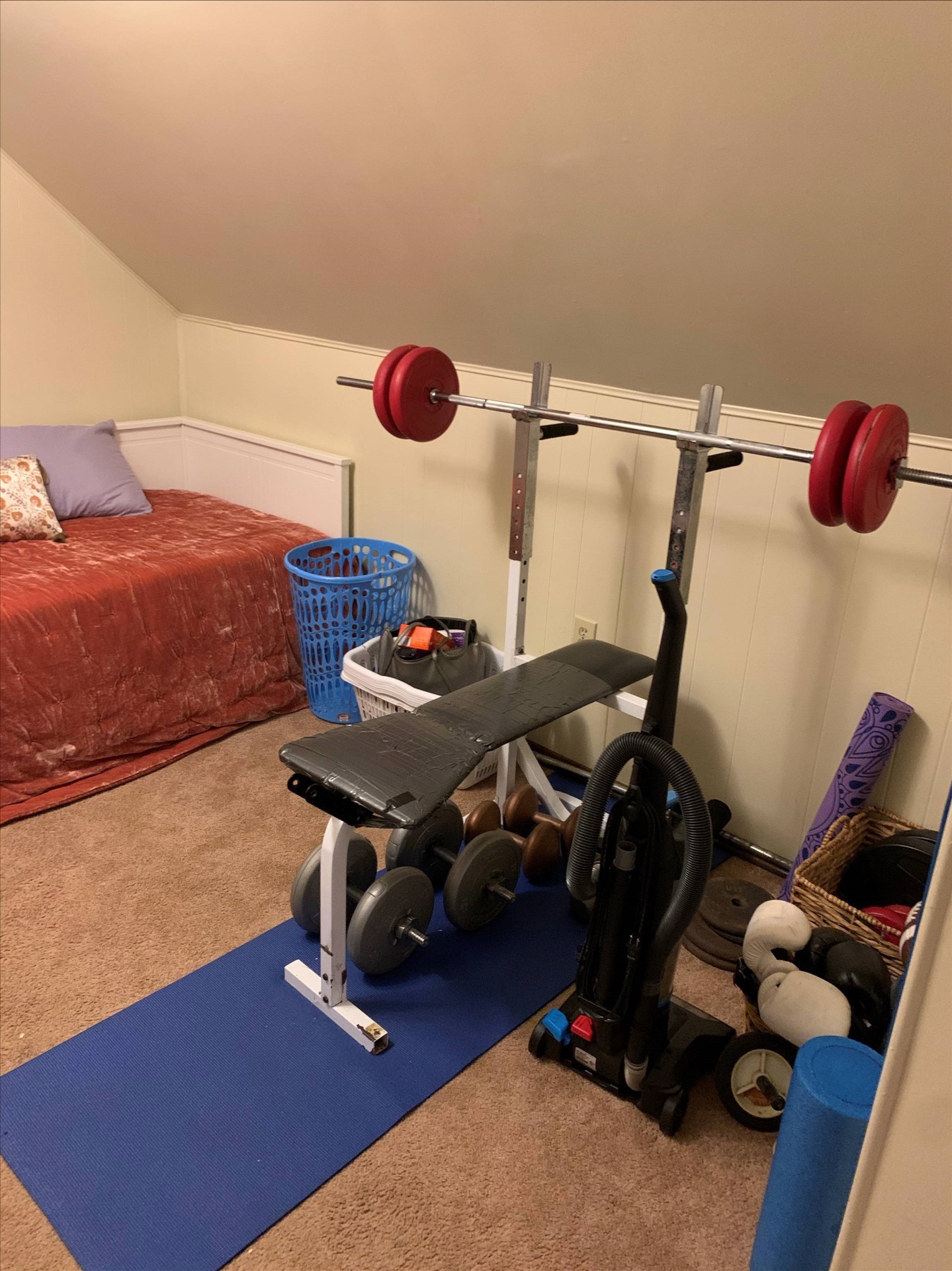 Home gym area with squat rack and weight bench in the flex room