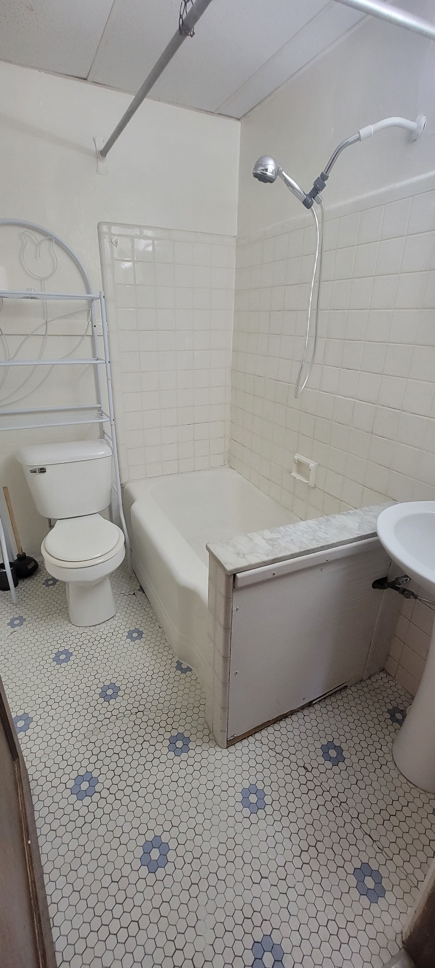 2054 Iuka Ave. A full bathroom with tub/shower, subway tile surround, and vintage hex tile floor
