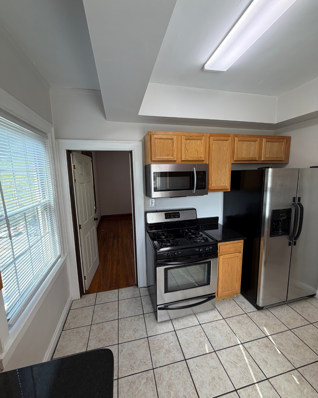 Kitchen with stainless steel appliances, gas range, and side-by-side fridge