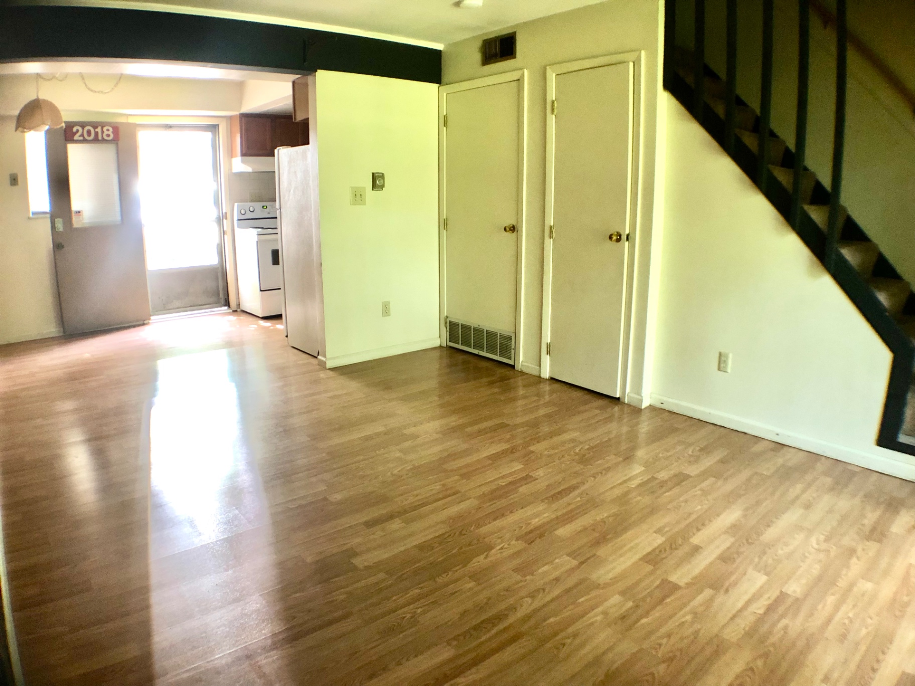 2018 Iuka Ave. living area with staircase, closets, and pass-through to the kitchen