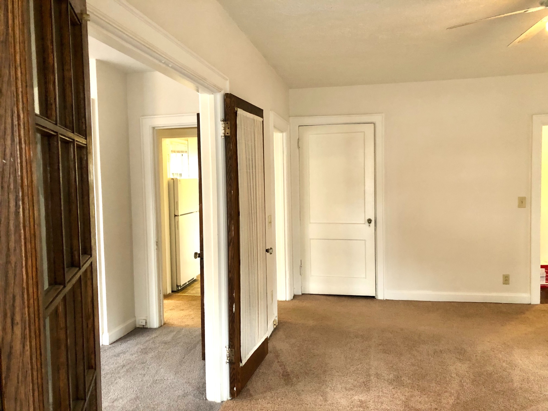 2044 Iuka Ave. B open hallway with original glass-paneled French door and view into kitchen