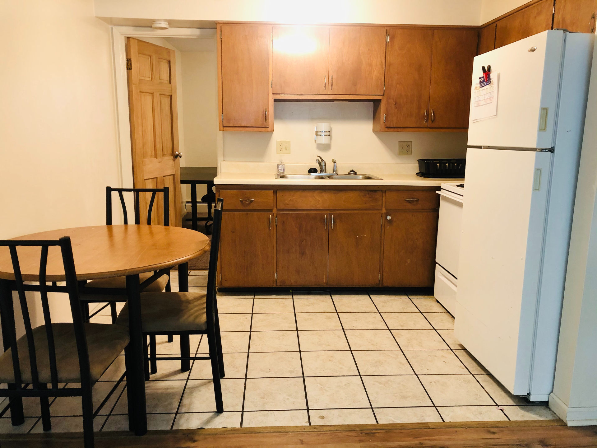 1827 N 4th St. Unit 2 kitchen with oak cabinets, white fridge, electric range, and tile floor