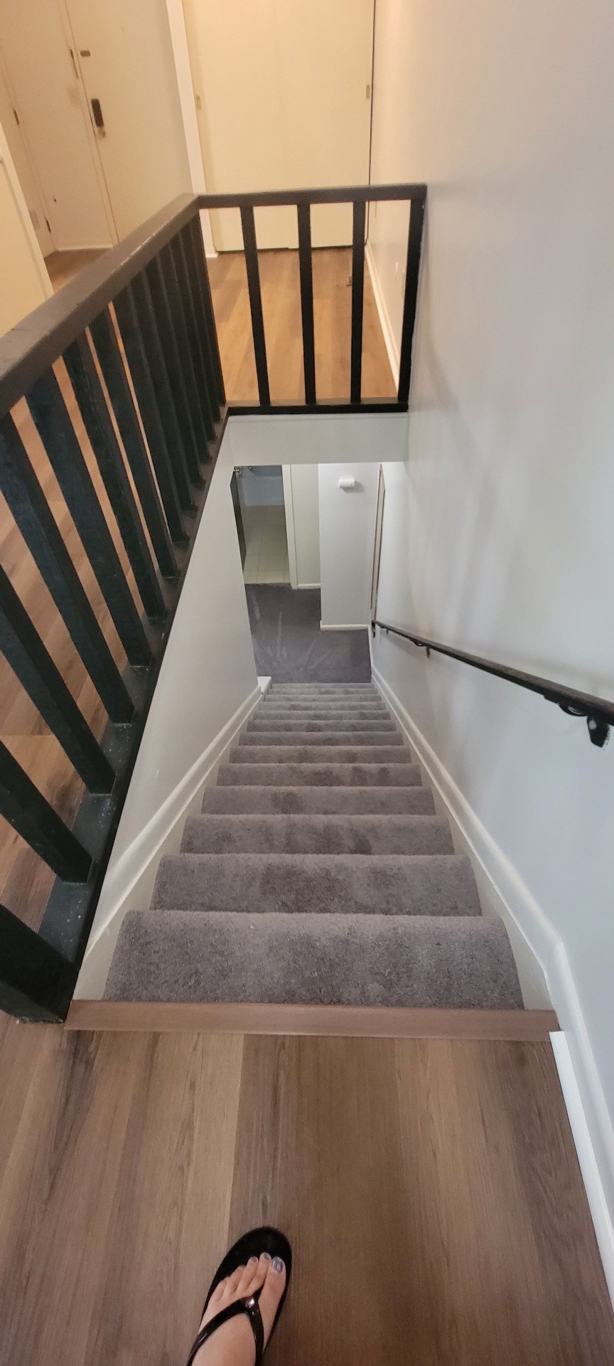 2022 Summit St. carpeted staircase leading to the upstairs bedrooms with plank flooring at the landing