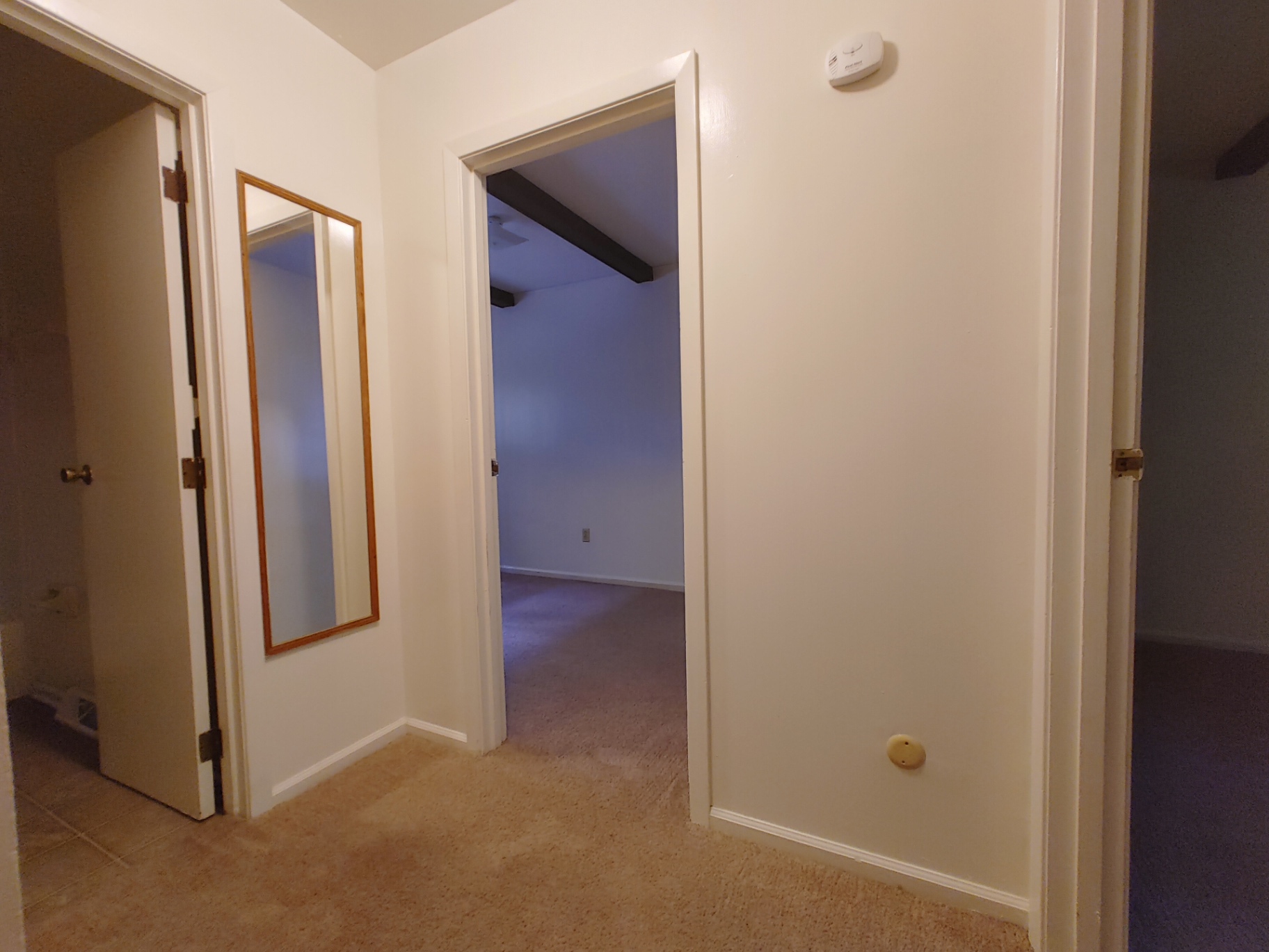 2018 Iuka Ave. upper hallway with mirror leading to bedrooms and bathroom